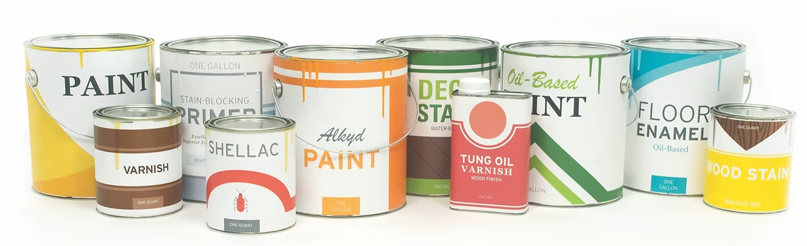 Several cans of paint are lined up in a row