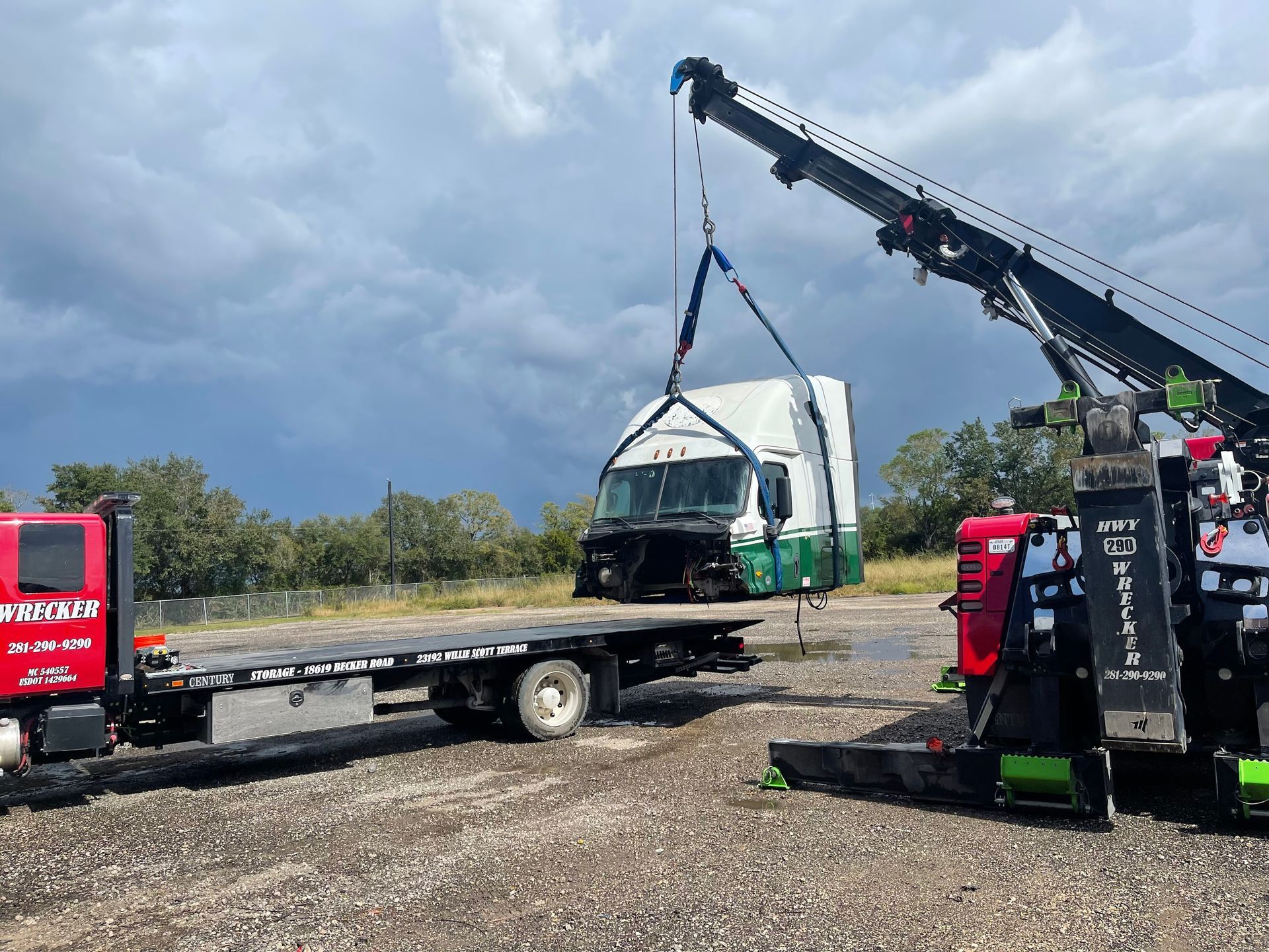 A tow truck with a crane attached to it