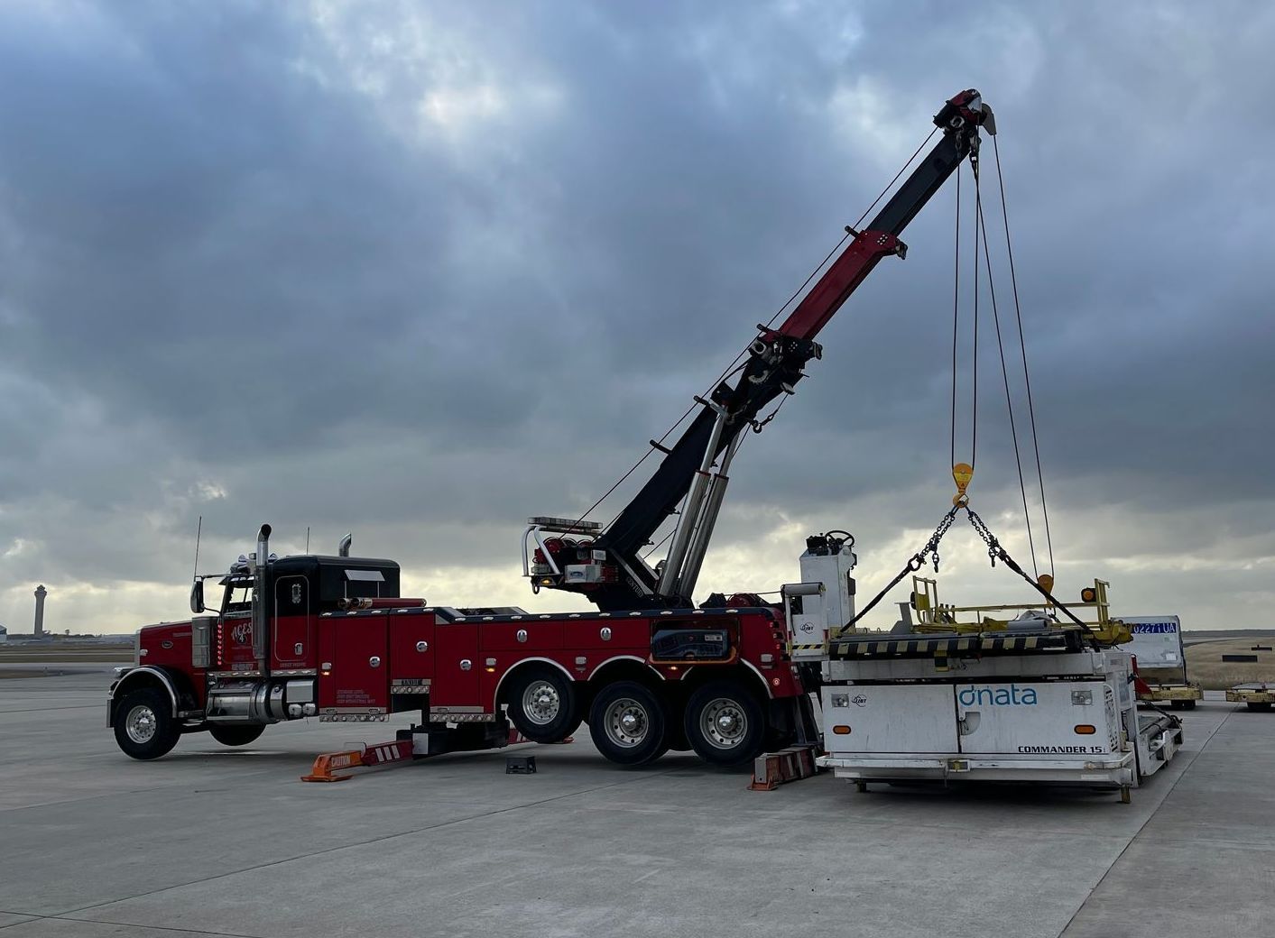 A tow truck with a crane attached to it