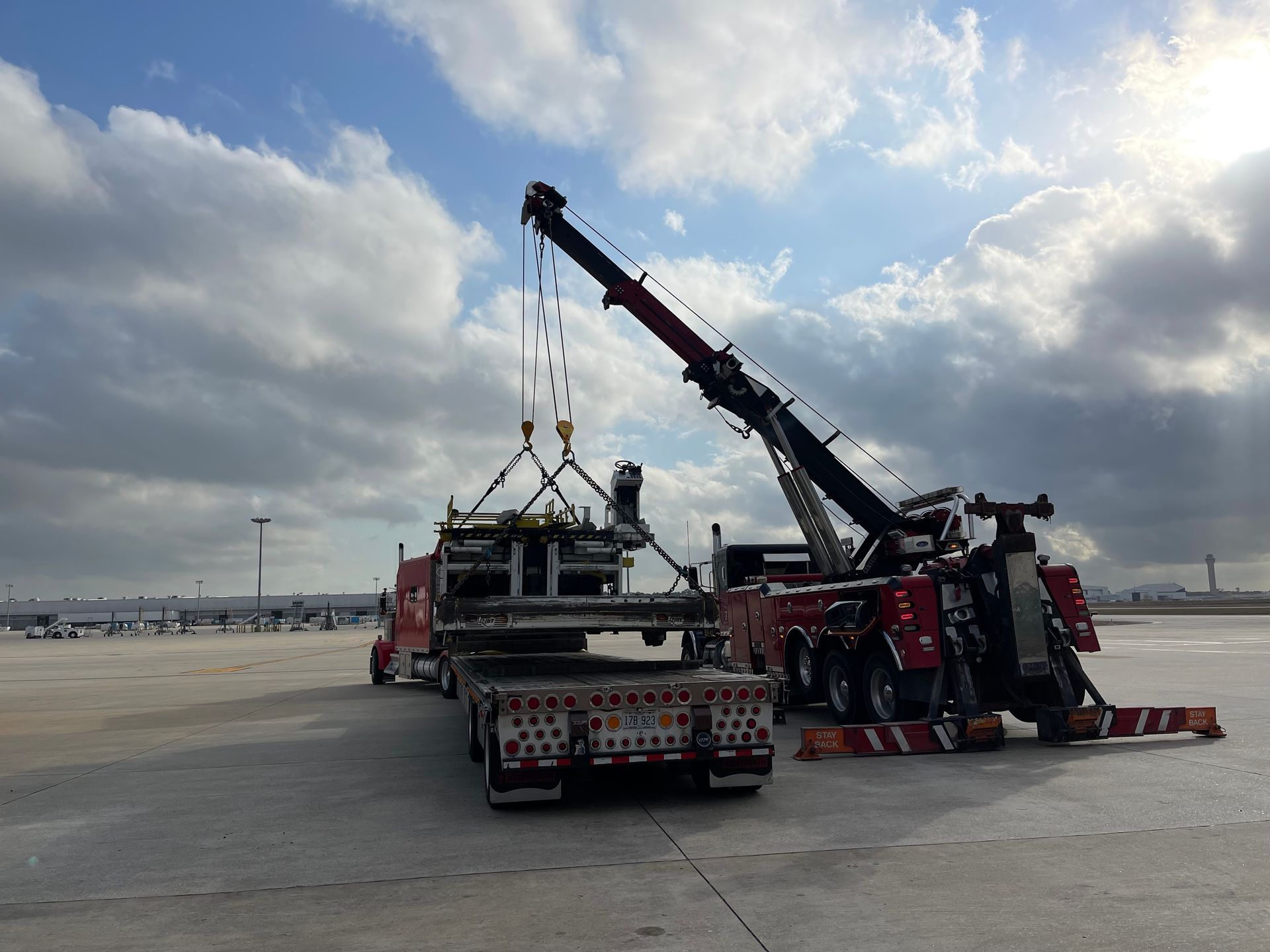 A tow truck with a crane attached to the back of it