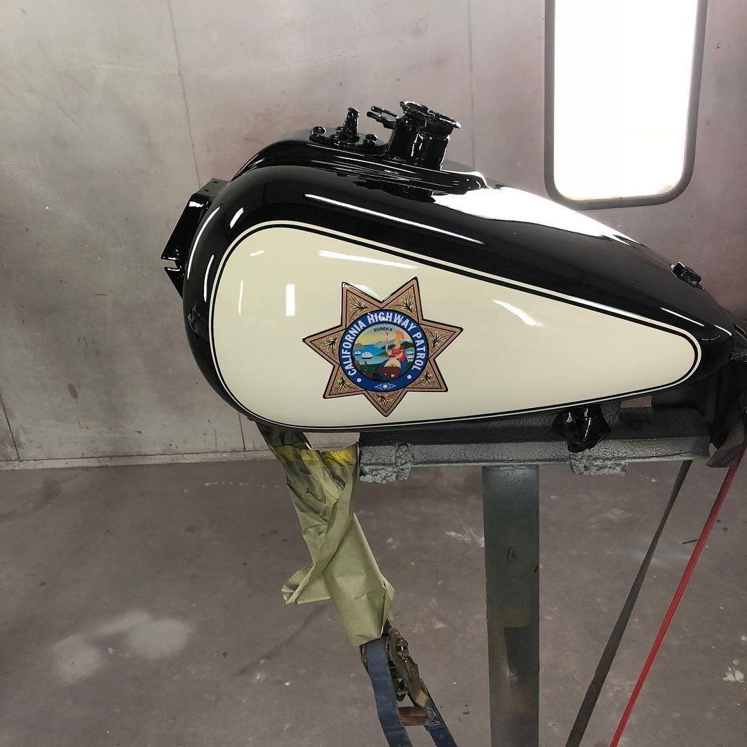 Motorcycle fuel tank, black and white paint, California Highway Patrol badge.