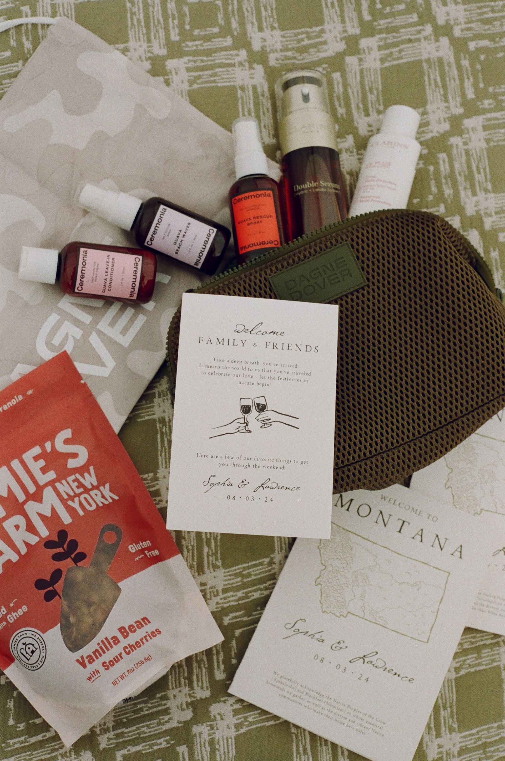 Assortment of skincare and beauty products, including bottles, tubes, and packages on patterned fabric.