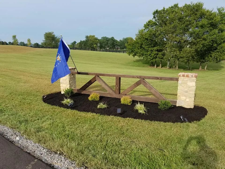 A wooden gate with a blue flag hanging from it