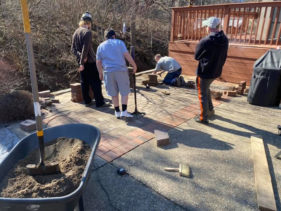 A group of people are working on a deck.