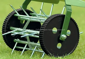 A lawn aerator is sitting on top of a lush green lawn