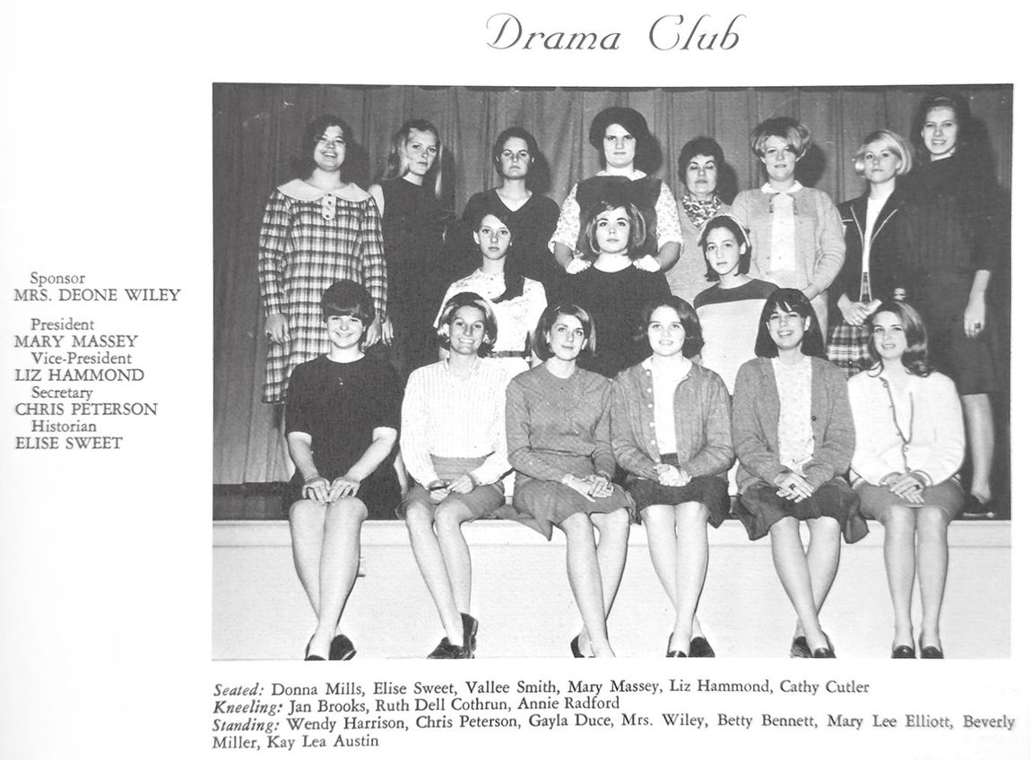 Drama Club group photo: students posing indoors, in front of a curtain.