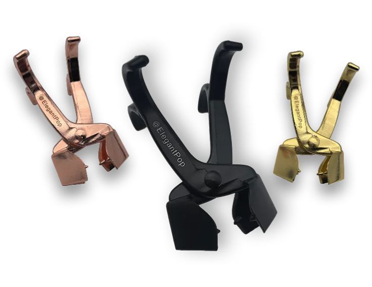 Three metal corner tools in bronze, black, and gold colors.