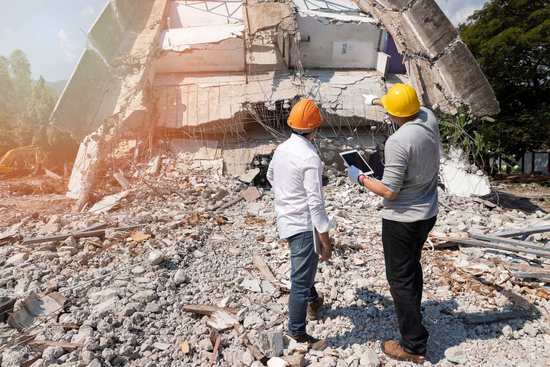 Demolition control supervisor and foreman discussing demolishing a building Demolition control supervisor and foreman discussing demolishing a building