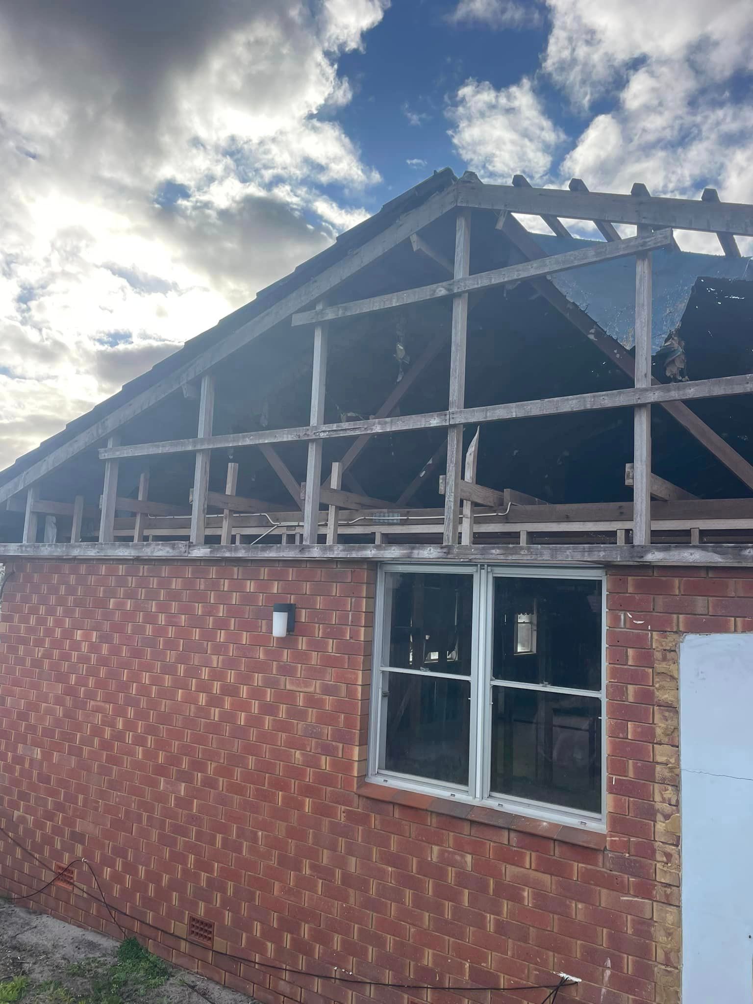Brick Building With A wooden Roof and Window.