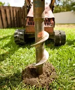 a tractor is drilling a hole in the ground