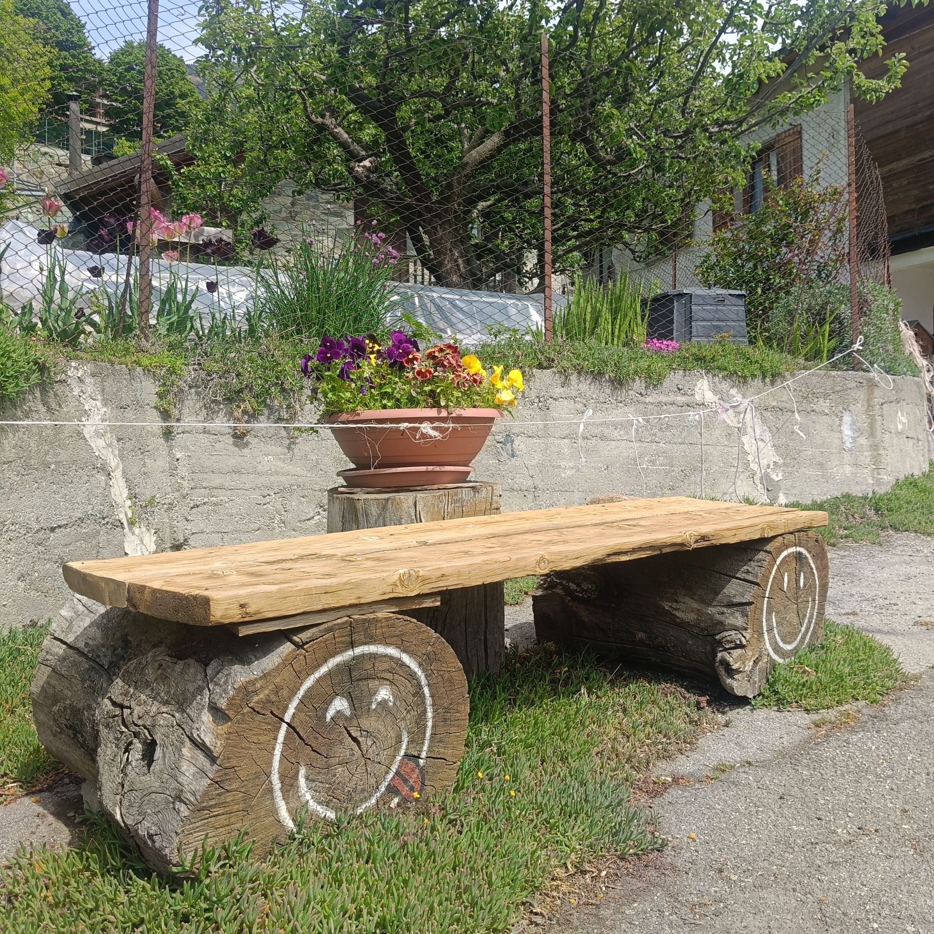 Flower-decorated bench in the village of Moron, Saint-Vincent