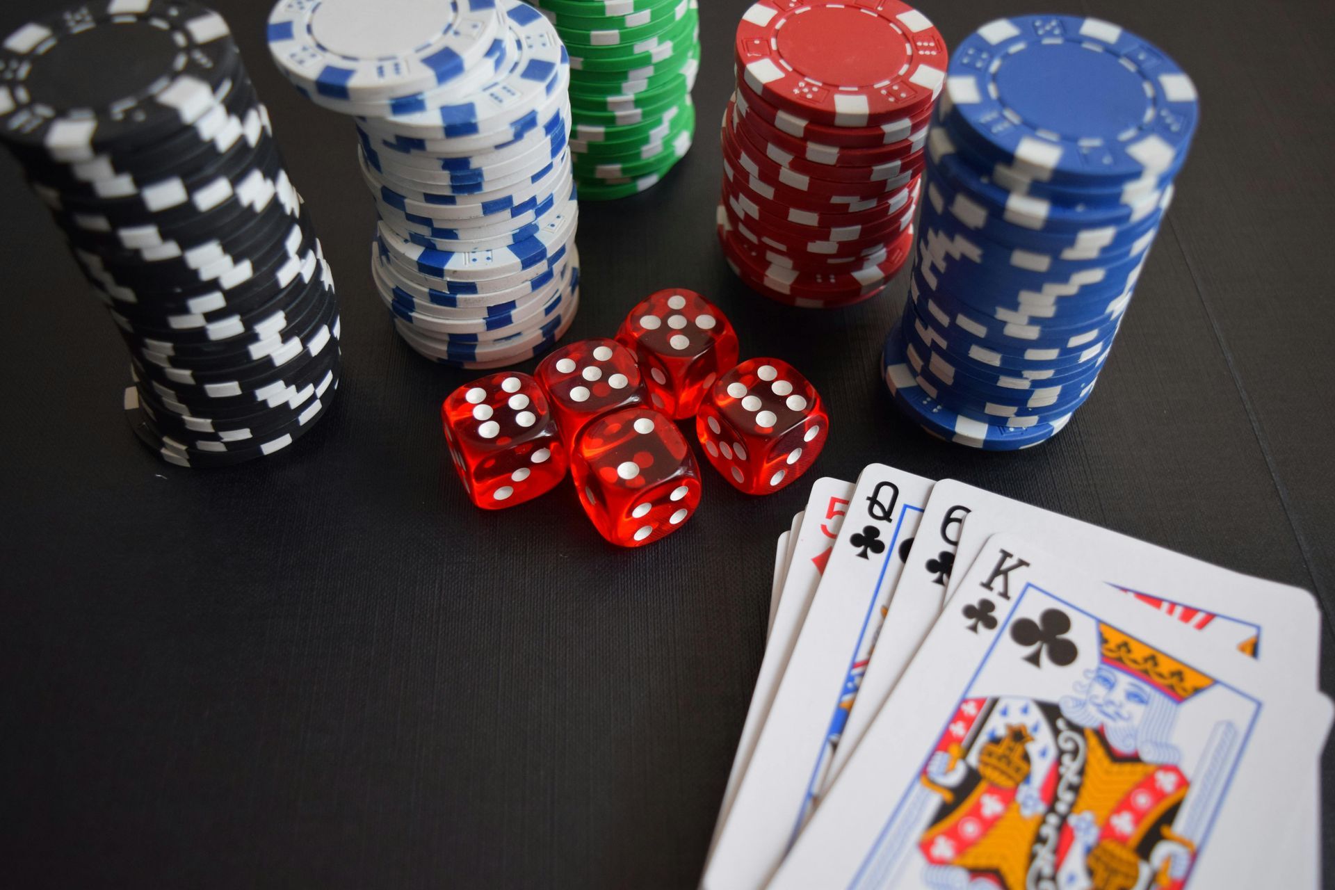 Concept image of Casino de la Vallée in Saint-Vincent, with dice and playing cards on a green table.