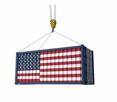 Shipping container with the United States flag hanging from a crane hook