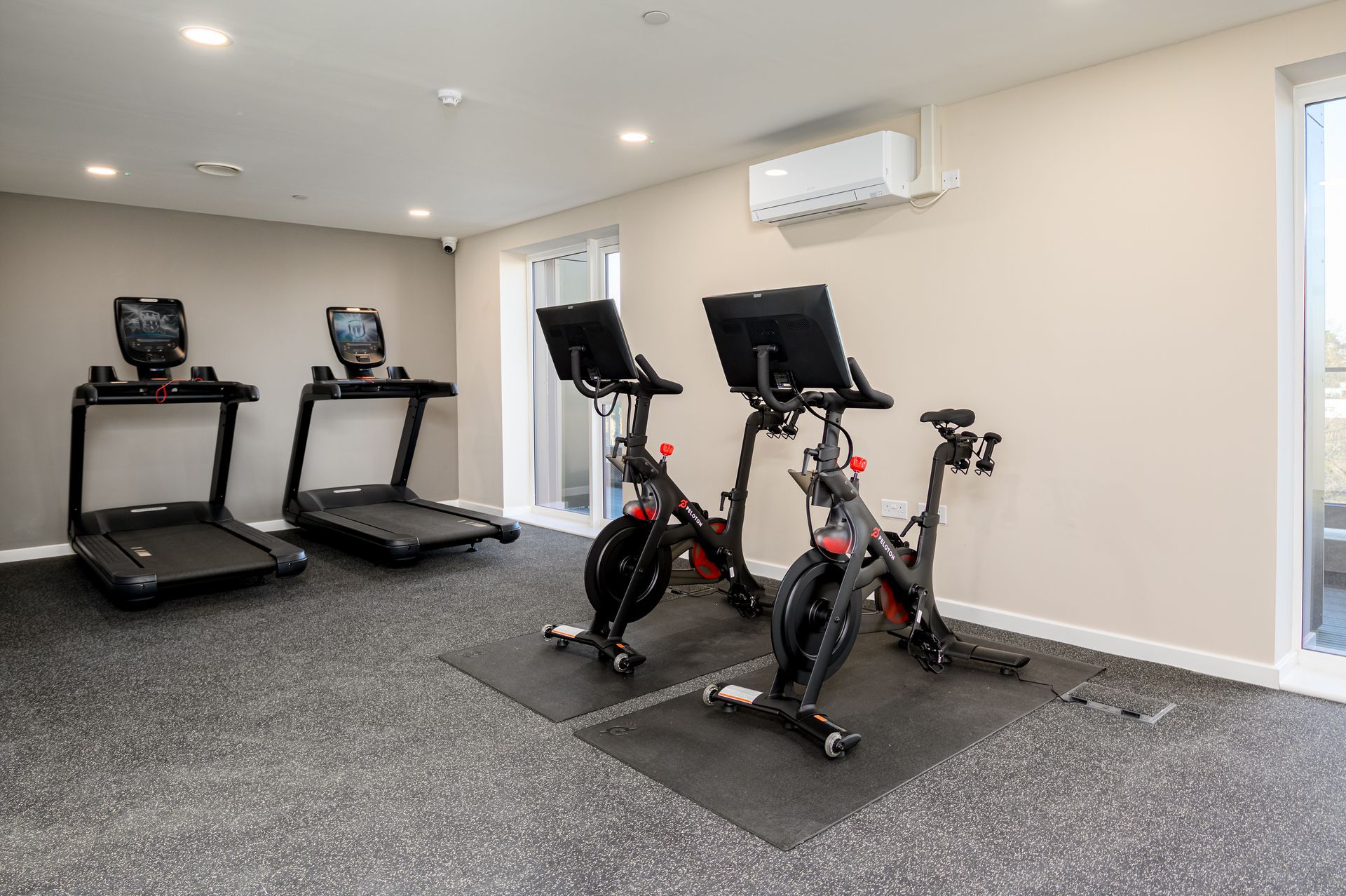 A gym with treadmills and exercise bikes.
