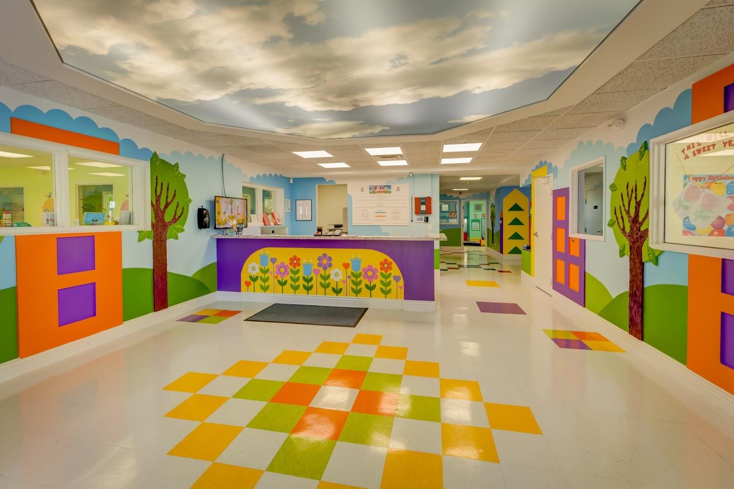 A hallway in a hospital with a checkered floor and colorful walls.
