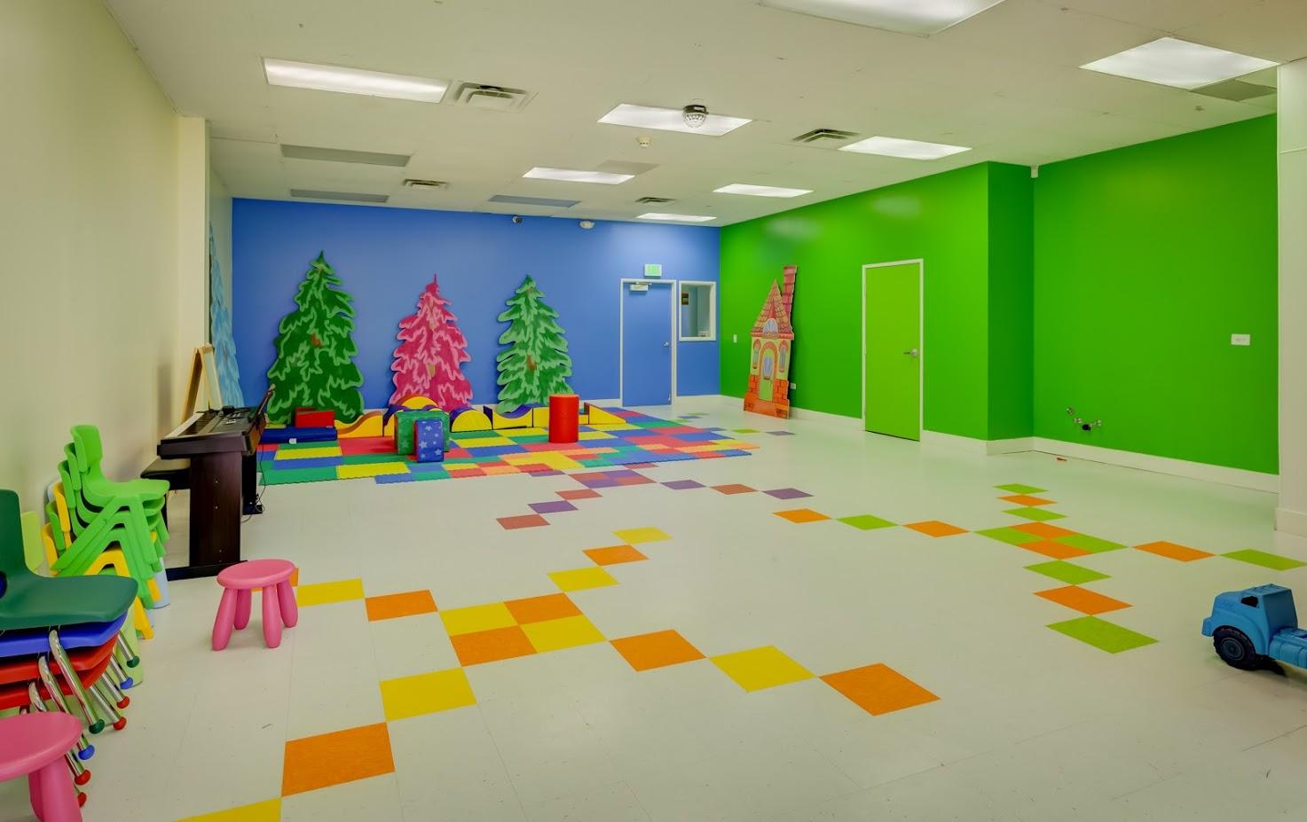 A large room with colorful tiles on the floor and walls.