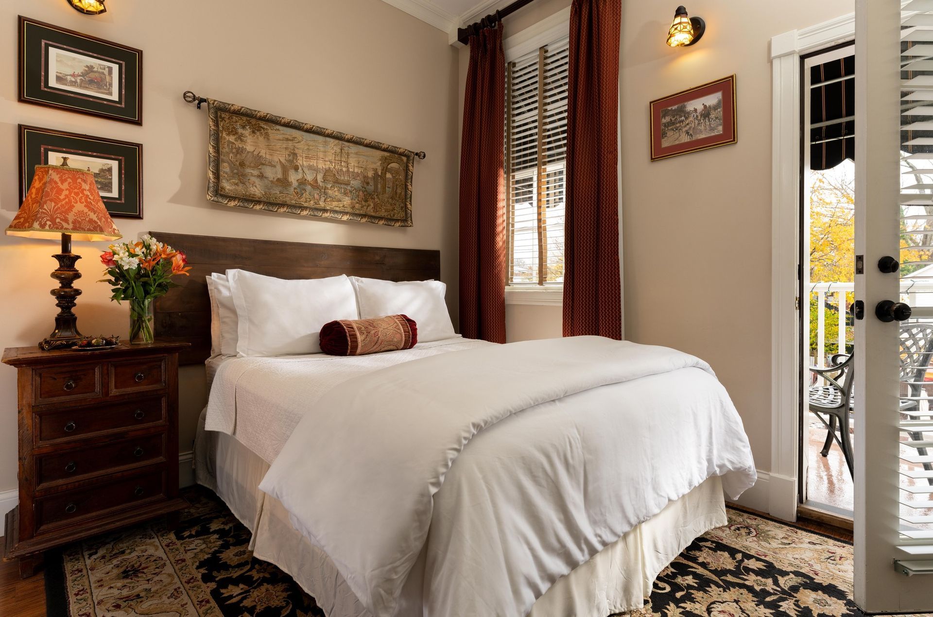 A bedroom with a sleigh bed and a table with food on it