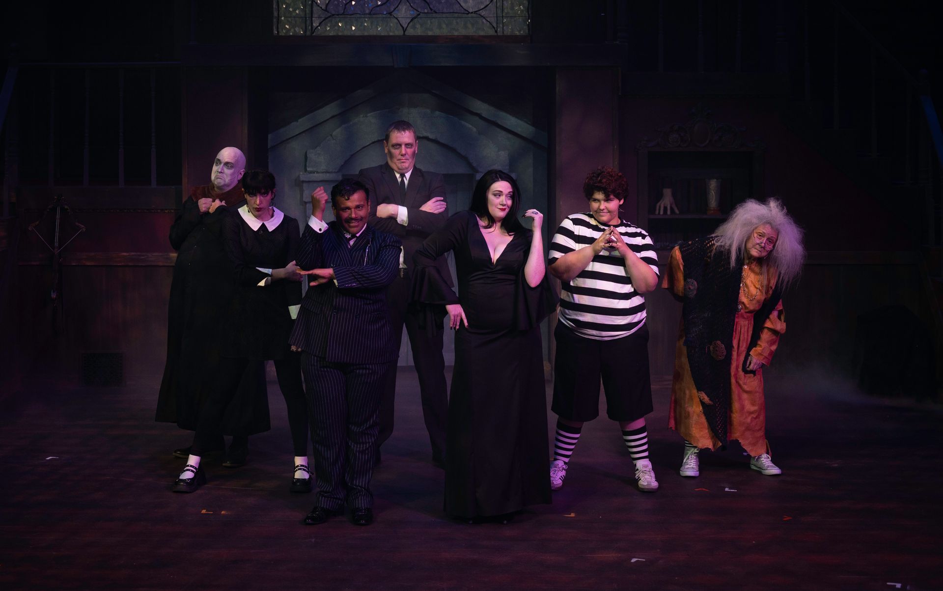 Cats musical stage production: Dancers in cat costumes, posing, on a colorful set.