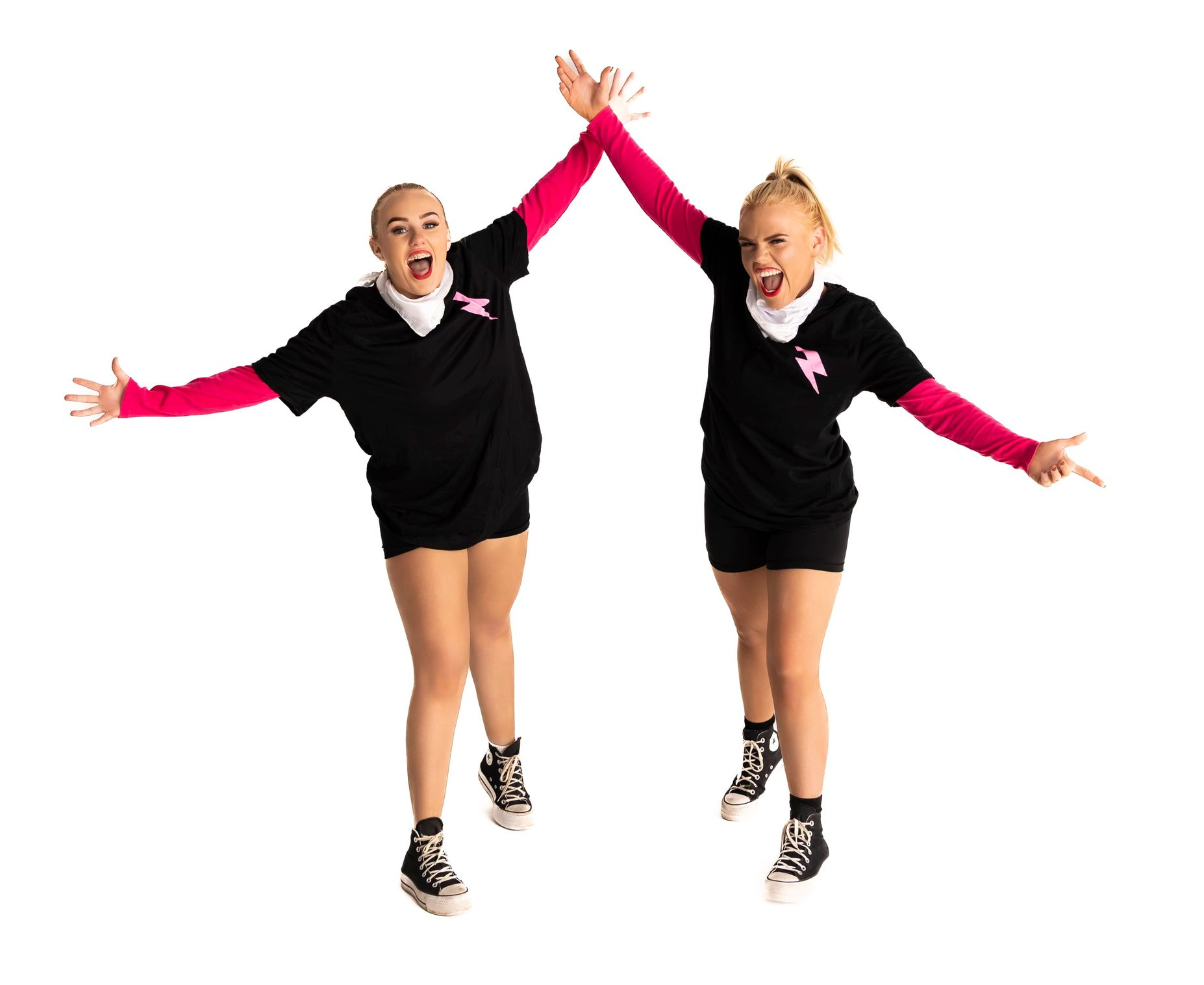 Two women in black shirts and shorts, pink sleeves, high-fiving — iDance Performance Co In Medowie, NSW