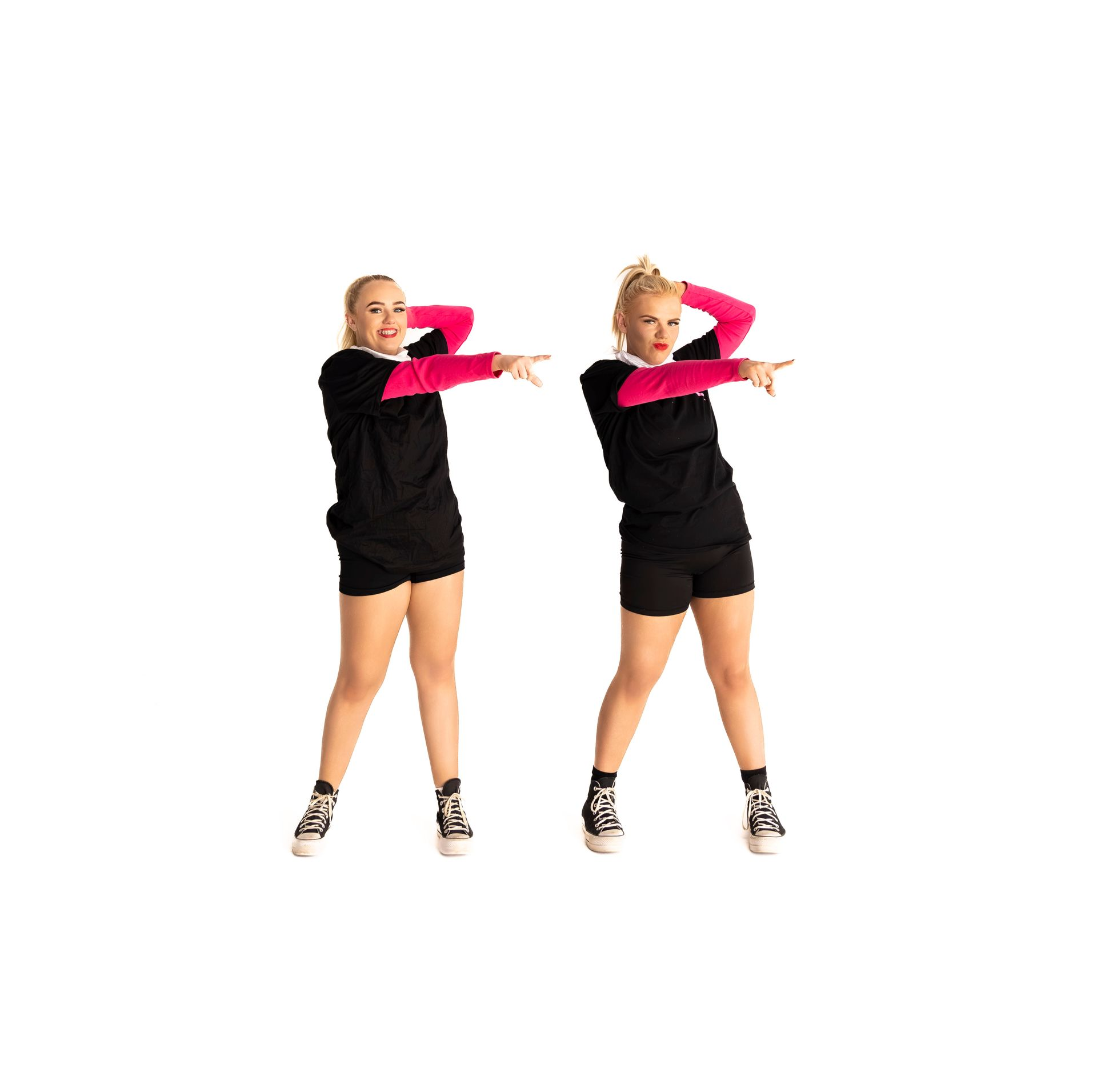 Two Dancers in Black and Pink Outfits Point to the Side, Smiling — iDance Performance Co In Medowie, NSW