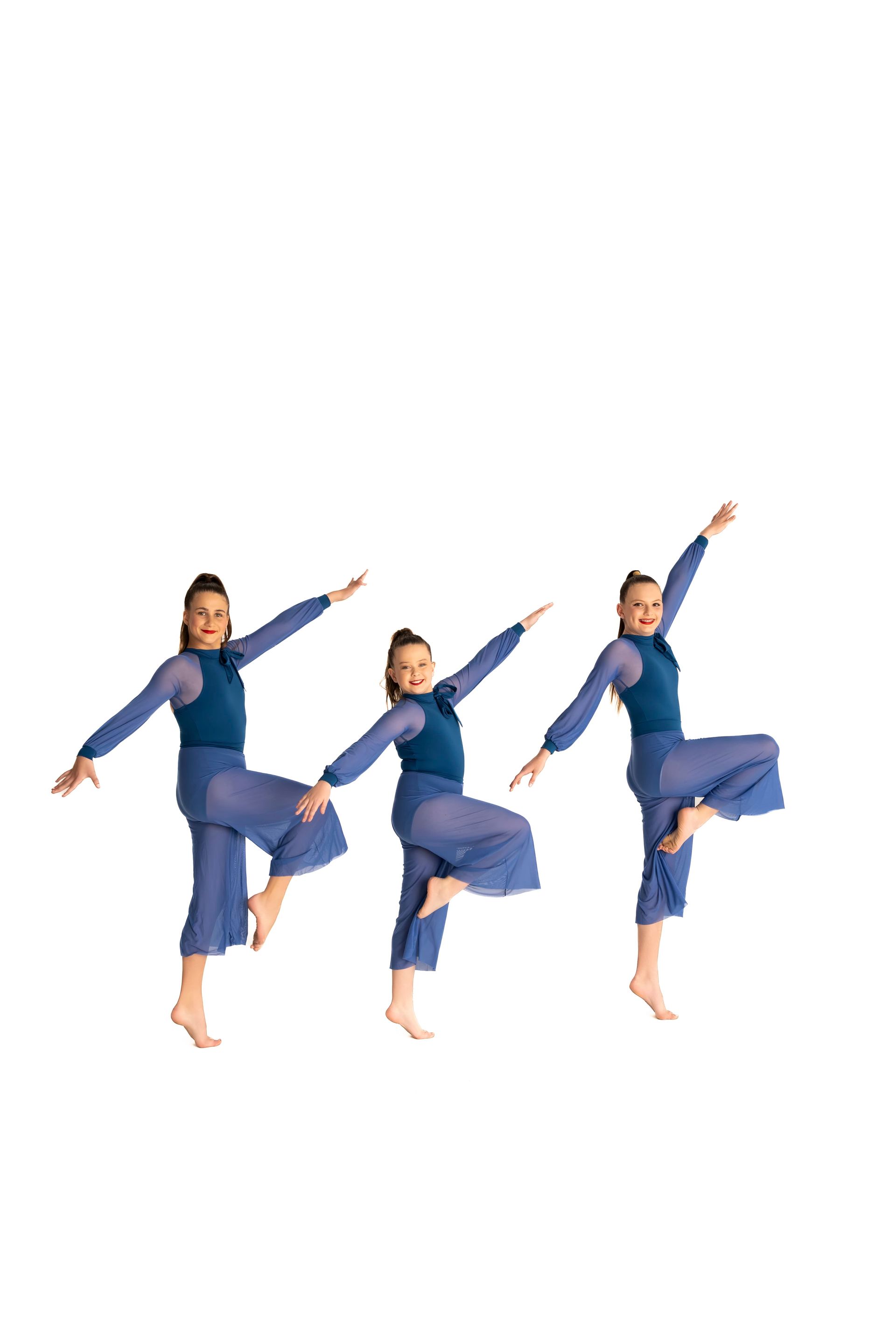Three dancers in blue outfits perform a ballet-style pose, arms outstretched, leg raised, barefoot — iDance Performance Co In Medowie, NSW