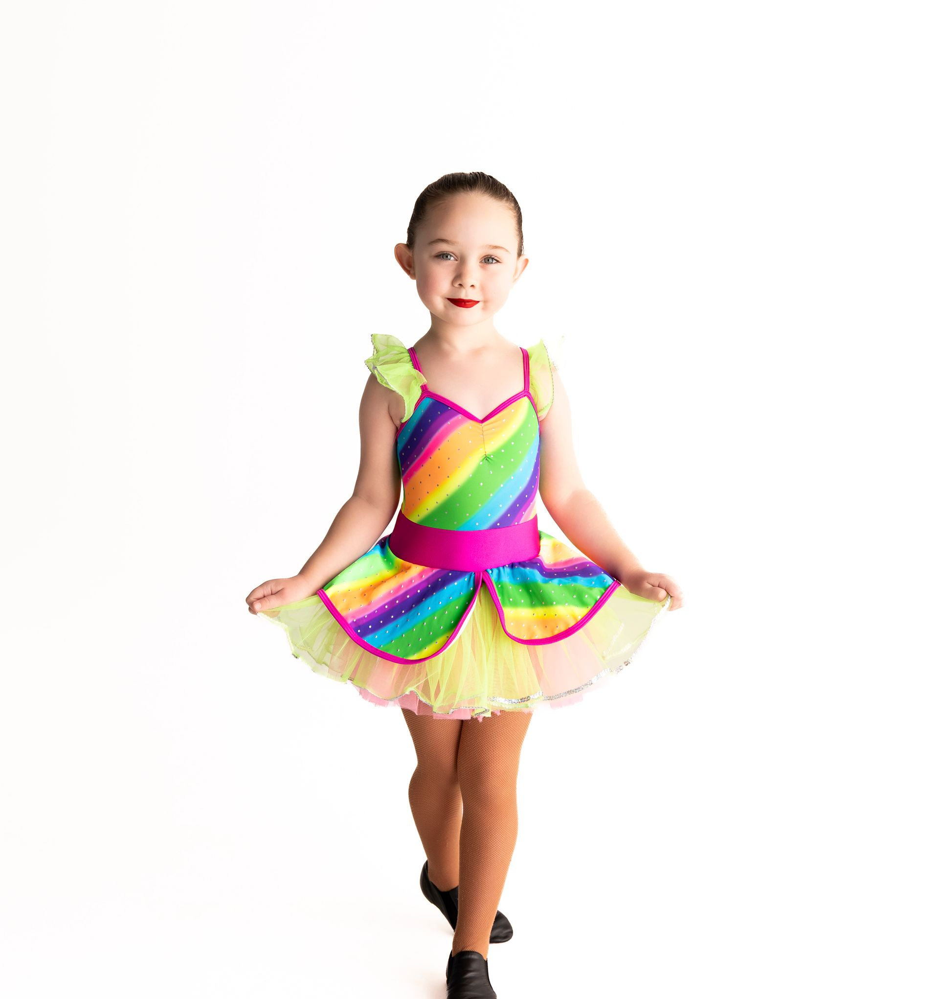 Girl in Rainbow Dance Costume, Smiling, Standing on Toes — iDance Performance Co In Medowie, NSW