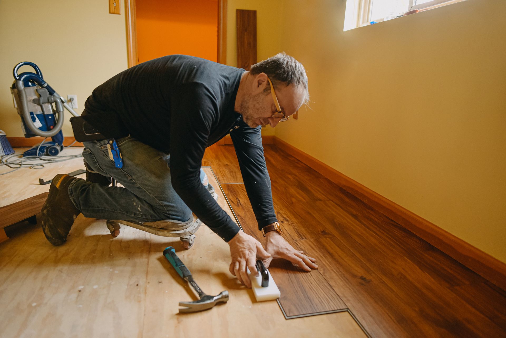 Man installing wood floor.