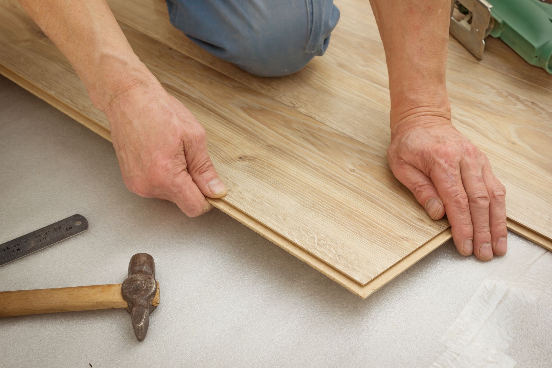 Installing laminate flooring.
