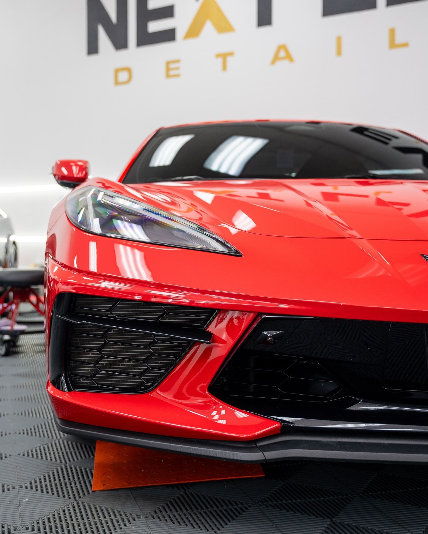 Bright red Corvette sports car in a garage with 