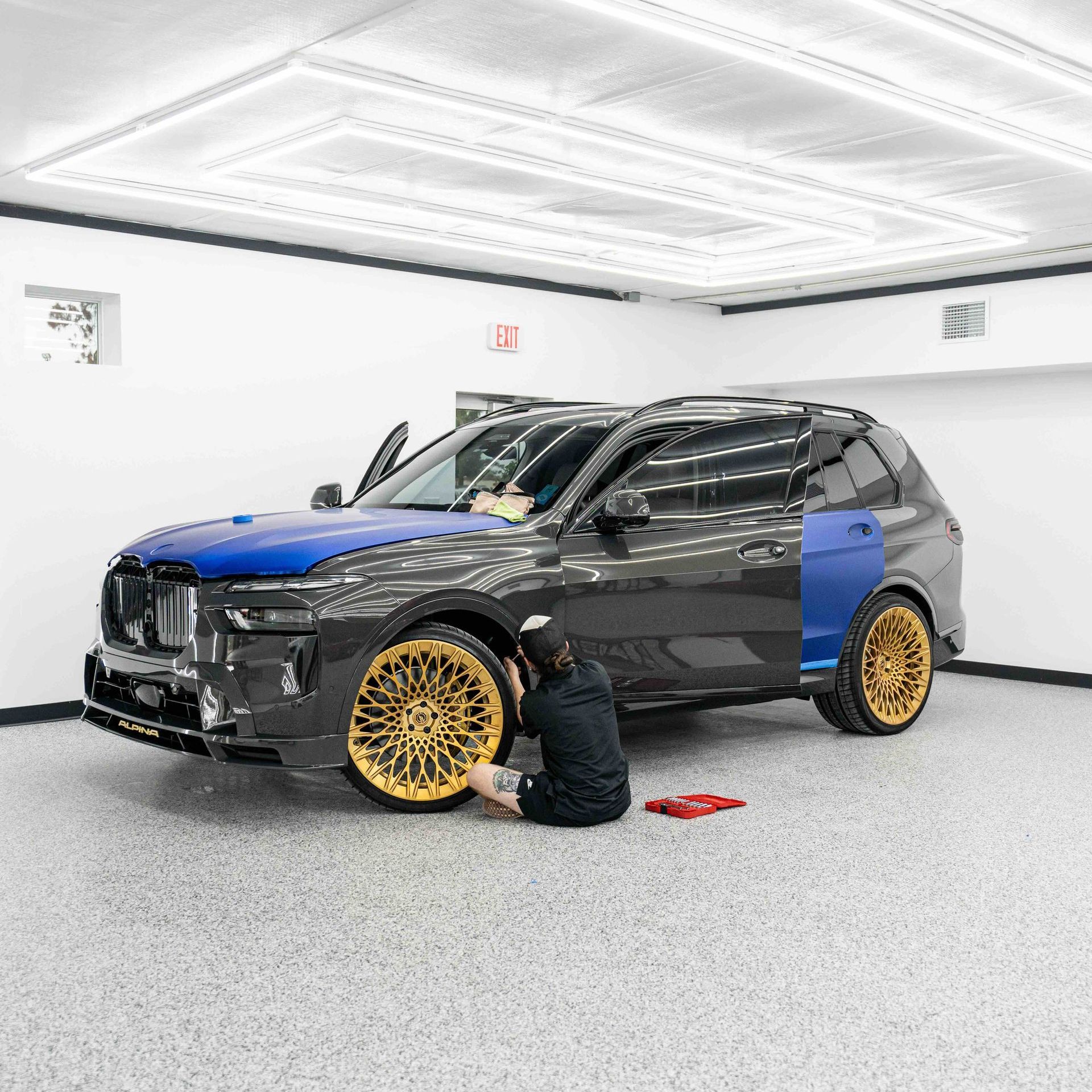 A tesla model y is parked in a garage.