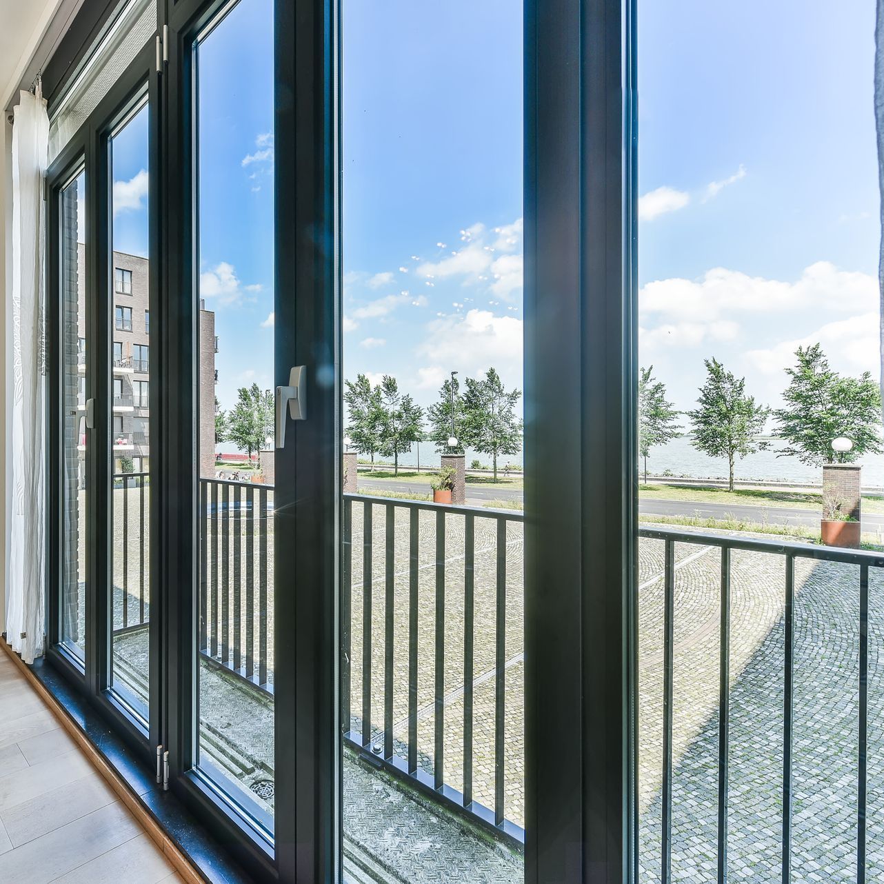A balcony with a fence and a lot of windows