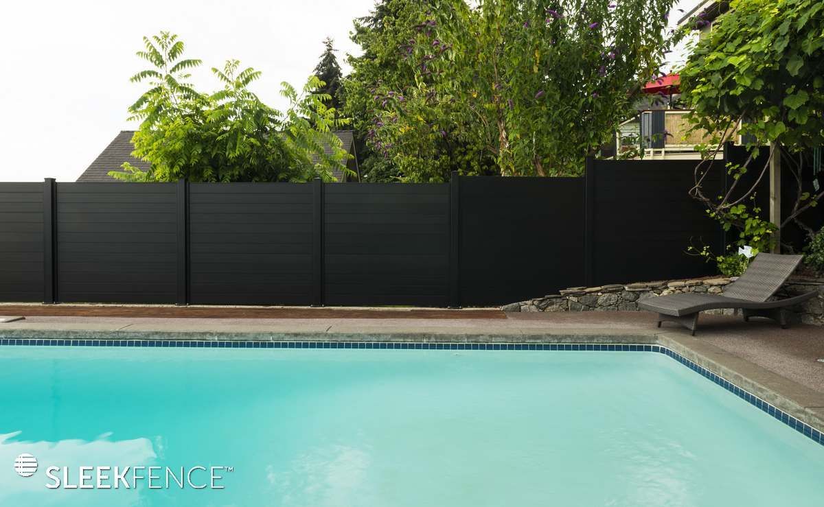 A swimming pool with a black fence surrounding it