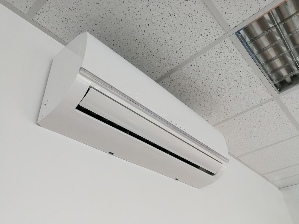 Man Checking The Air Conditioner In The Room — Oriel Refrigeration and Air Conditioning in Narromine, NSW
