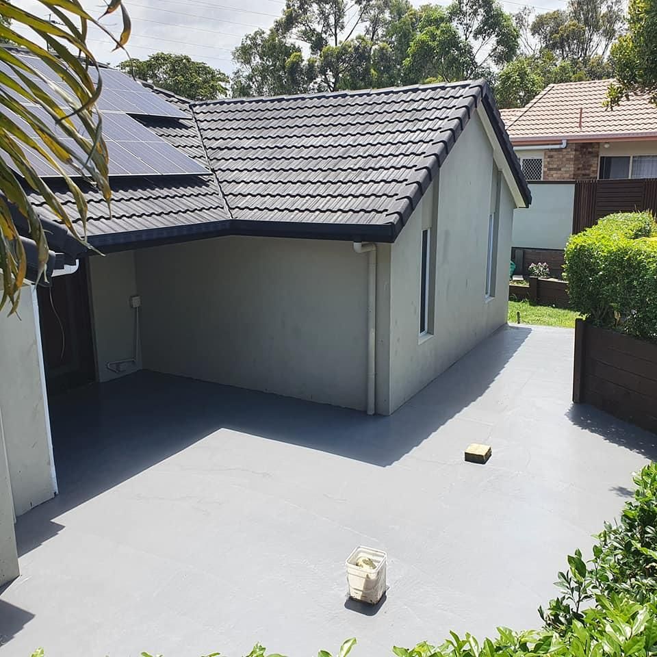 A House with A Gray Driveway and A Black Roof — Kontek Constructions in Jimboomba, QLD