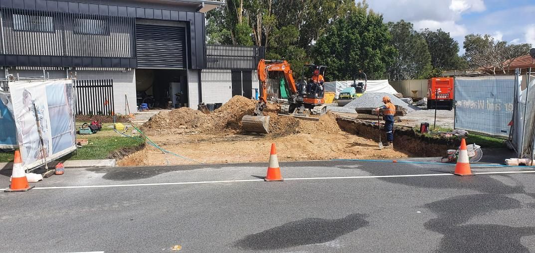 A Construction Site with A Lot of Cones on The Side of The Road — Kontek Constructions in Brisbane, QLD