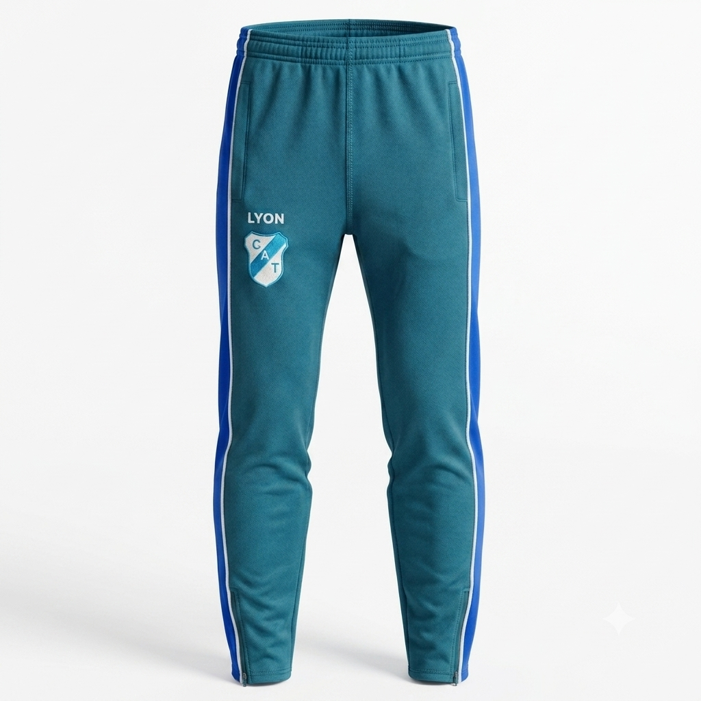Pantalones deportivos de color verde azulado con rayas laterales azules y el logotipo del OL Lyon en el muslo.