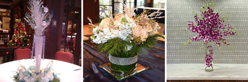 Three floral arrangements in glass vases, featuring white and purple flowers on display tables.