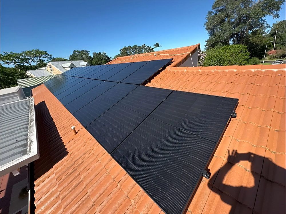 Black Solar Panels On A Tiled Roof In Lismore