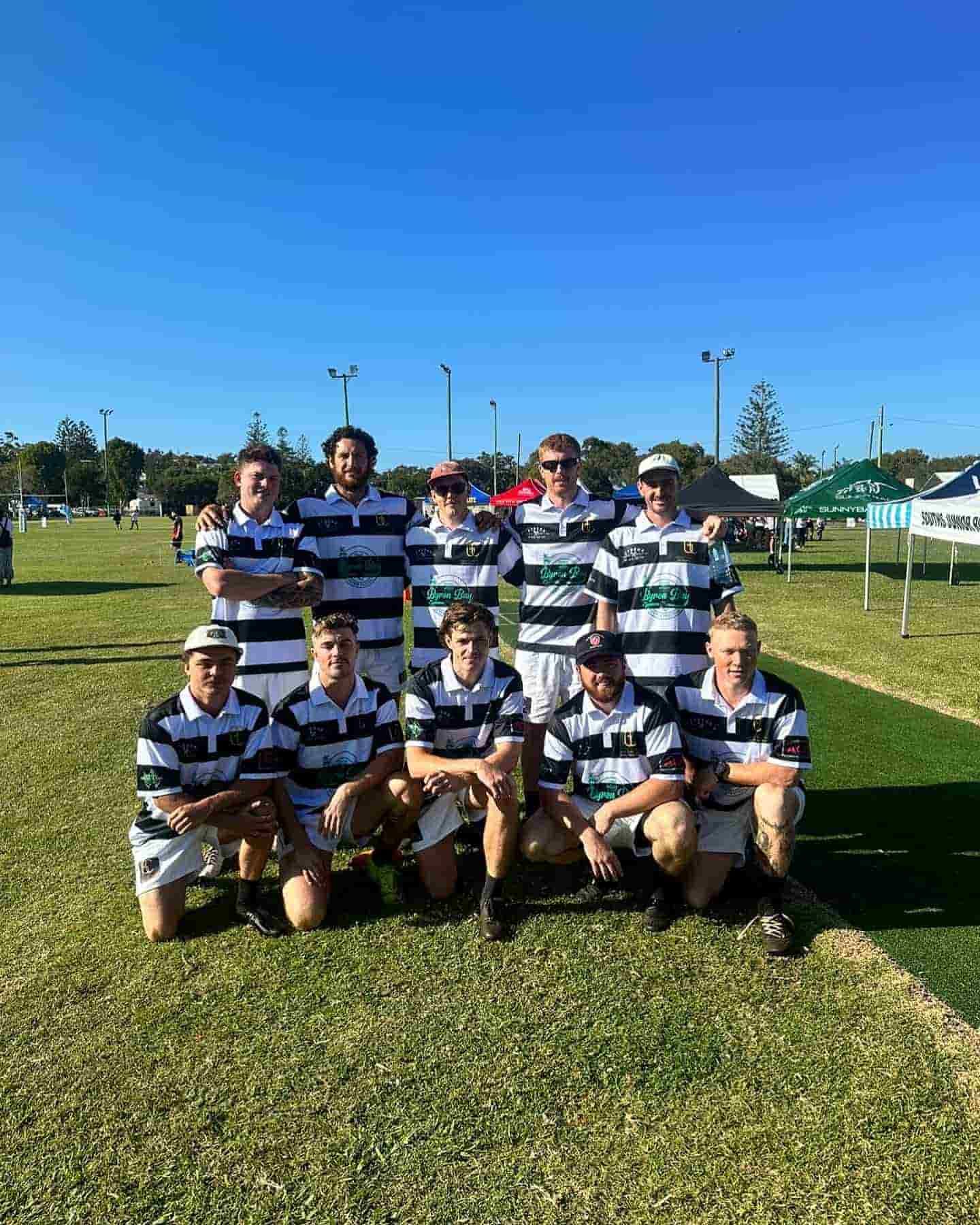 A Group Of Rugby Players Are Posing For A Picture On A Field — Grand Casa Electrical Solar & Batteries In Wollongbar, NSW