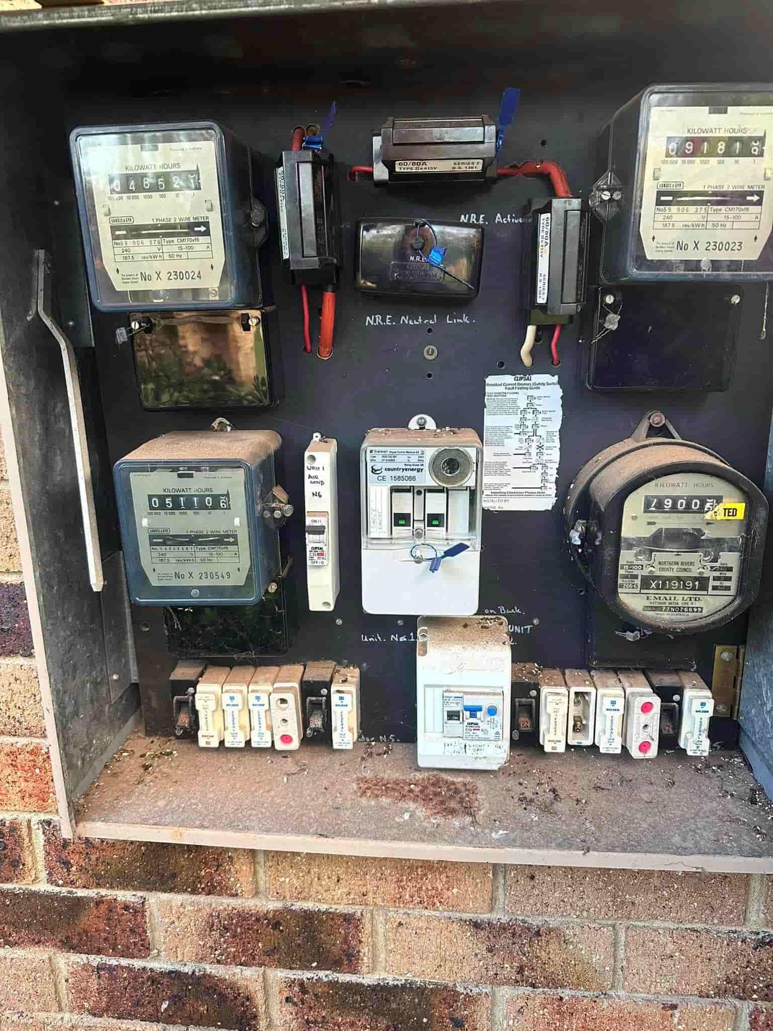 A Bunch Of Electrical Meters Are Sitting On Top Of A Brick Wall — Grand Casa Electrical Solar & Batteries In Byron Bay, NSW