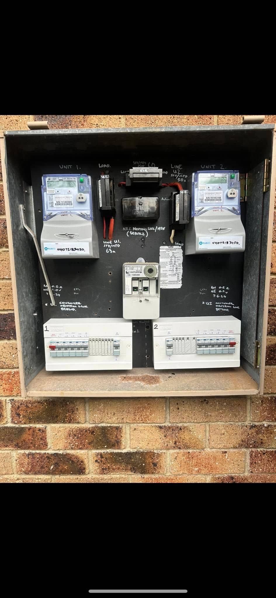 Old Electrical Meter Box With Two Meters and Wiring Inside a Rusted Wall Recess — Grand Casa Electrical Solar & Batteries In Northern Rivers, NSW