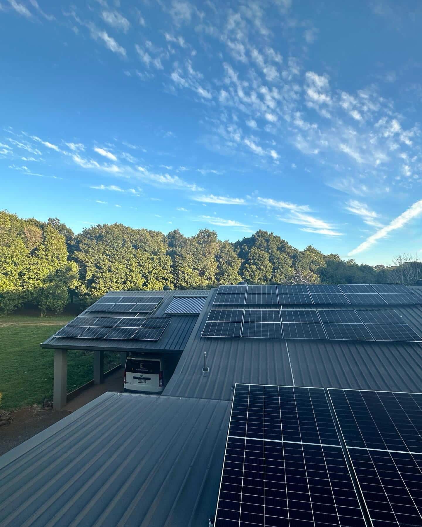 A Car Is Parked Under A Carport With Solar Panels On The Roof — Grand Casa Electrical Solar & Batteries In Wollongbar, NSW