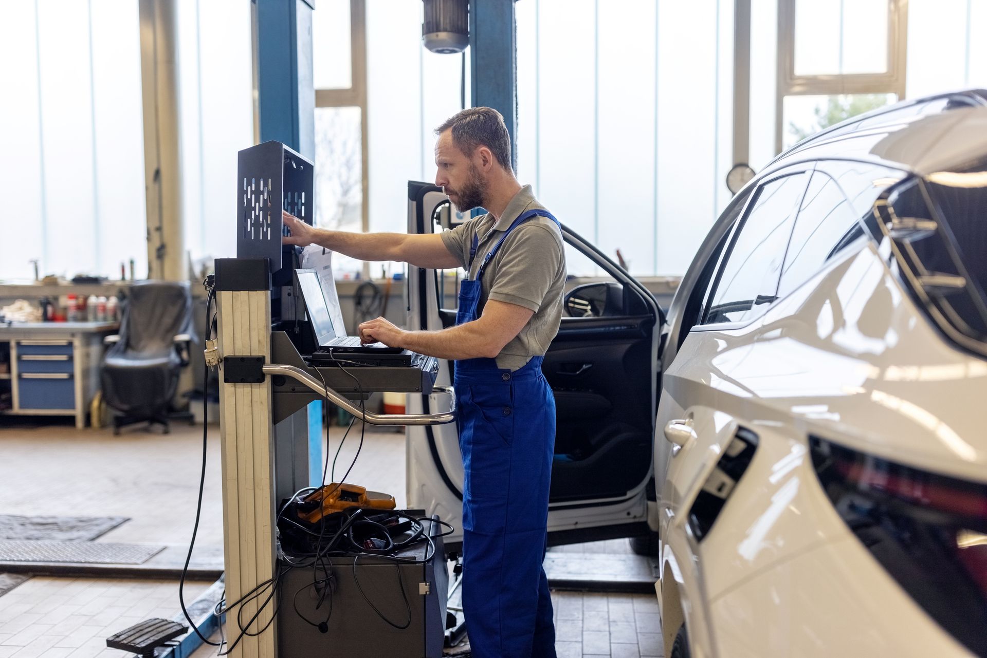 A man is working on a car in a garage.