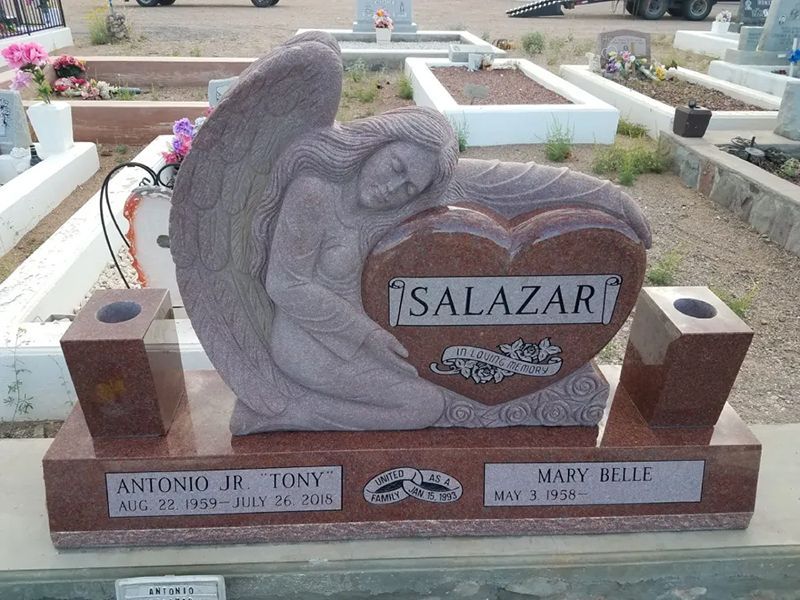 Upright headstone with angel hugging heart