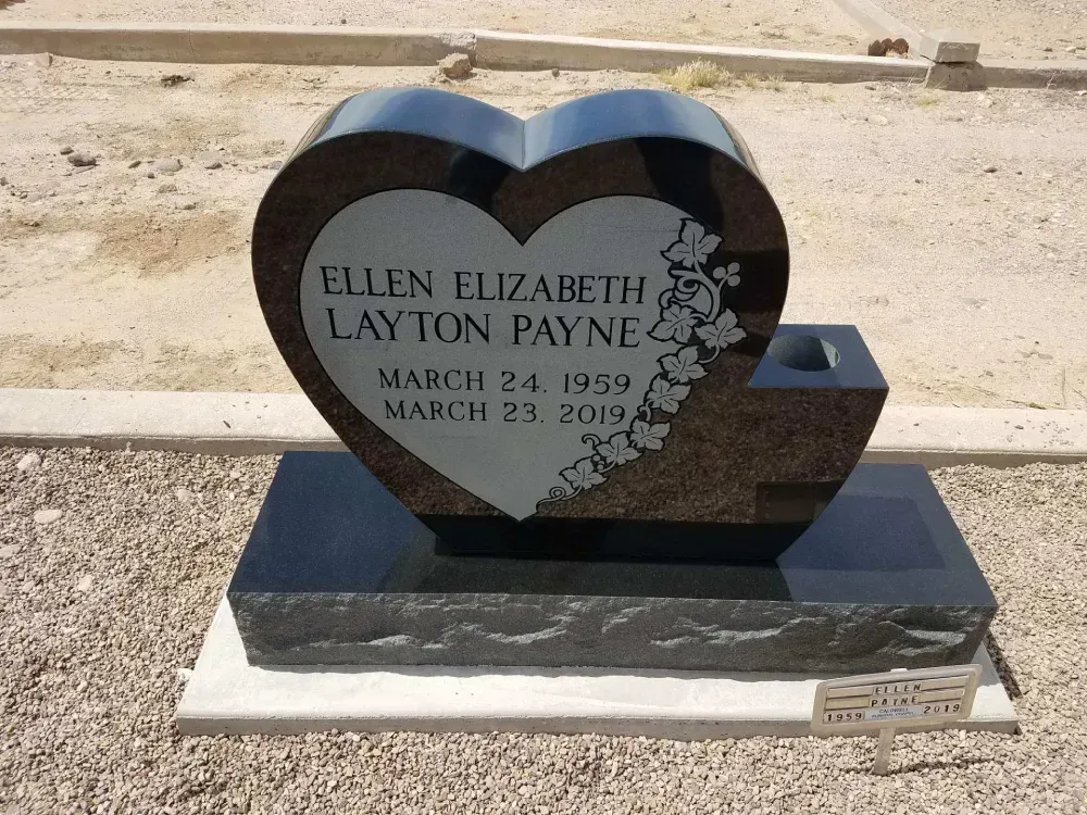 Heart shaped upright headstone with leaves carved in.