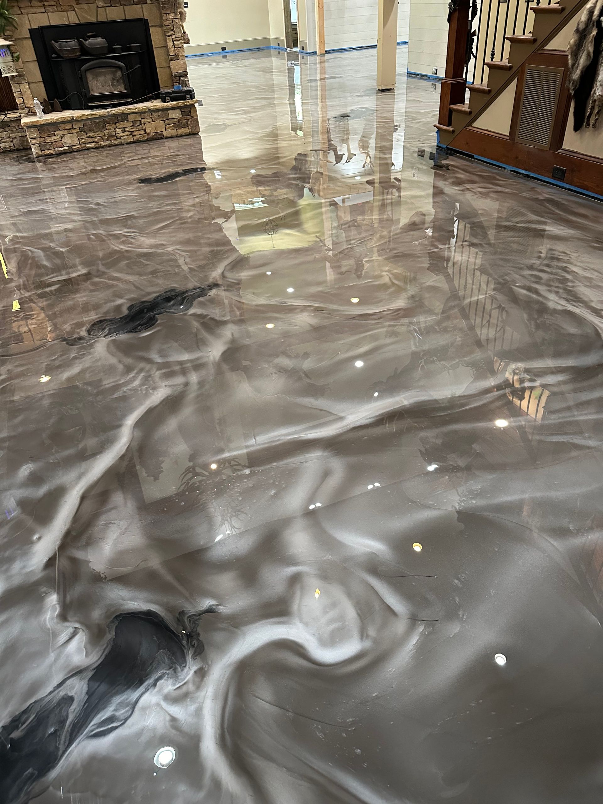 Flooded living room with muddy water covering the floor and reflecting furniture
