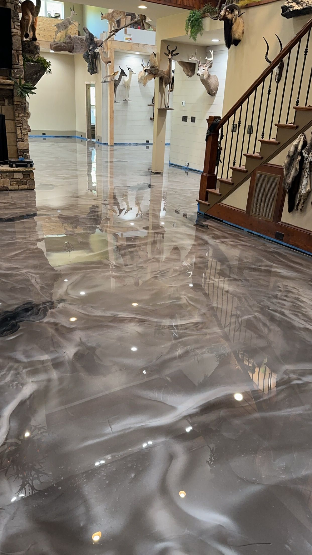 Marbled epoxy floor in a bright lobby with staircase and decorative pillars
