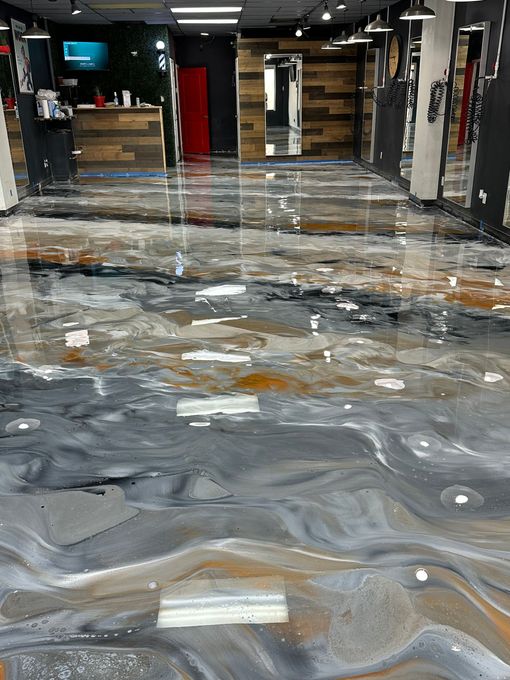 Empty industrial hallway with glossy speckled floor and corrugated metal walls