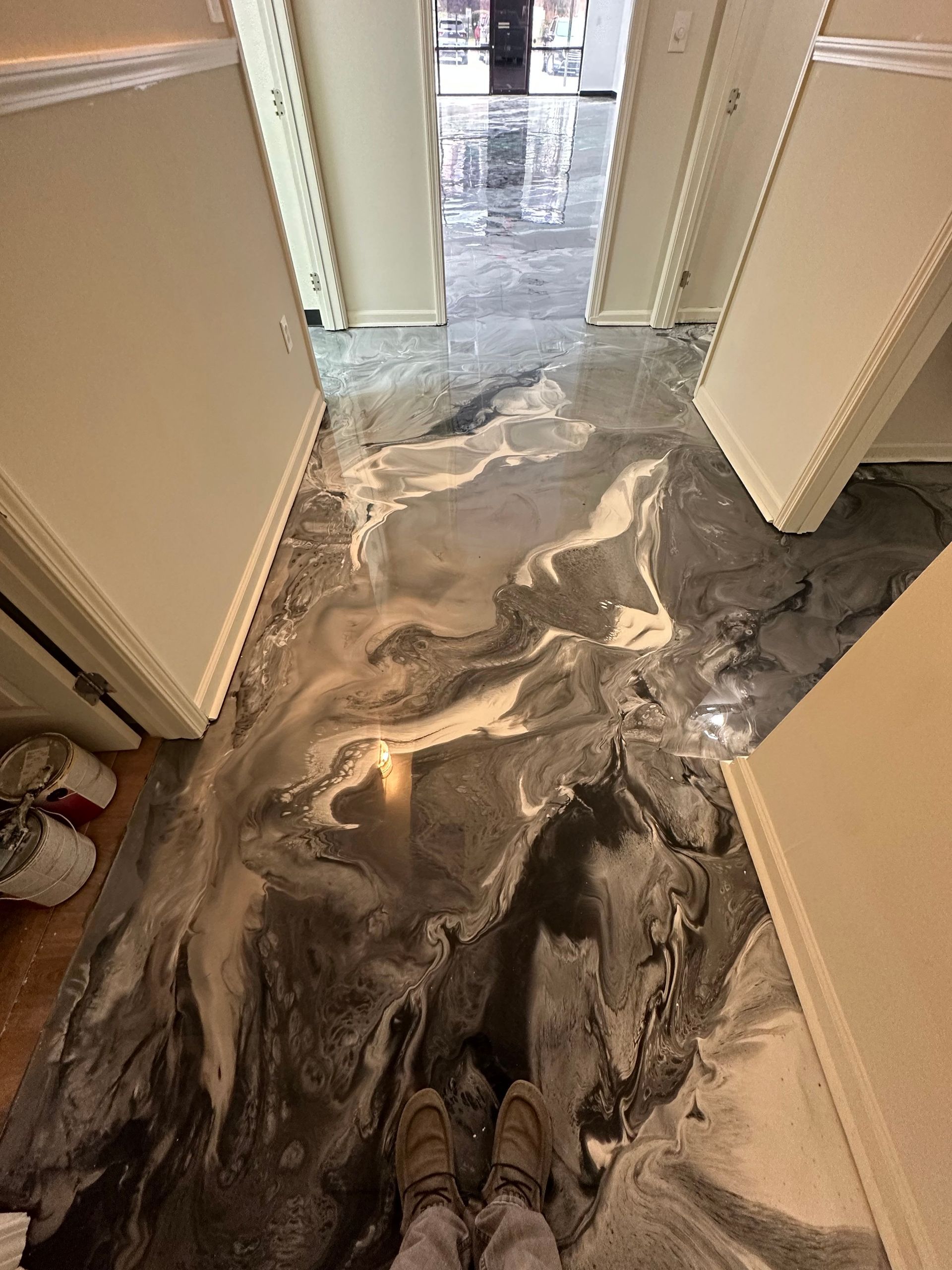 Flooded hallway with swirling water and wet floors extending through a doorway