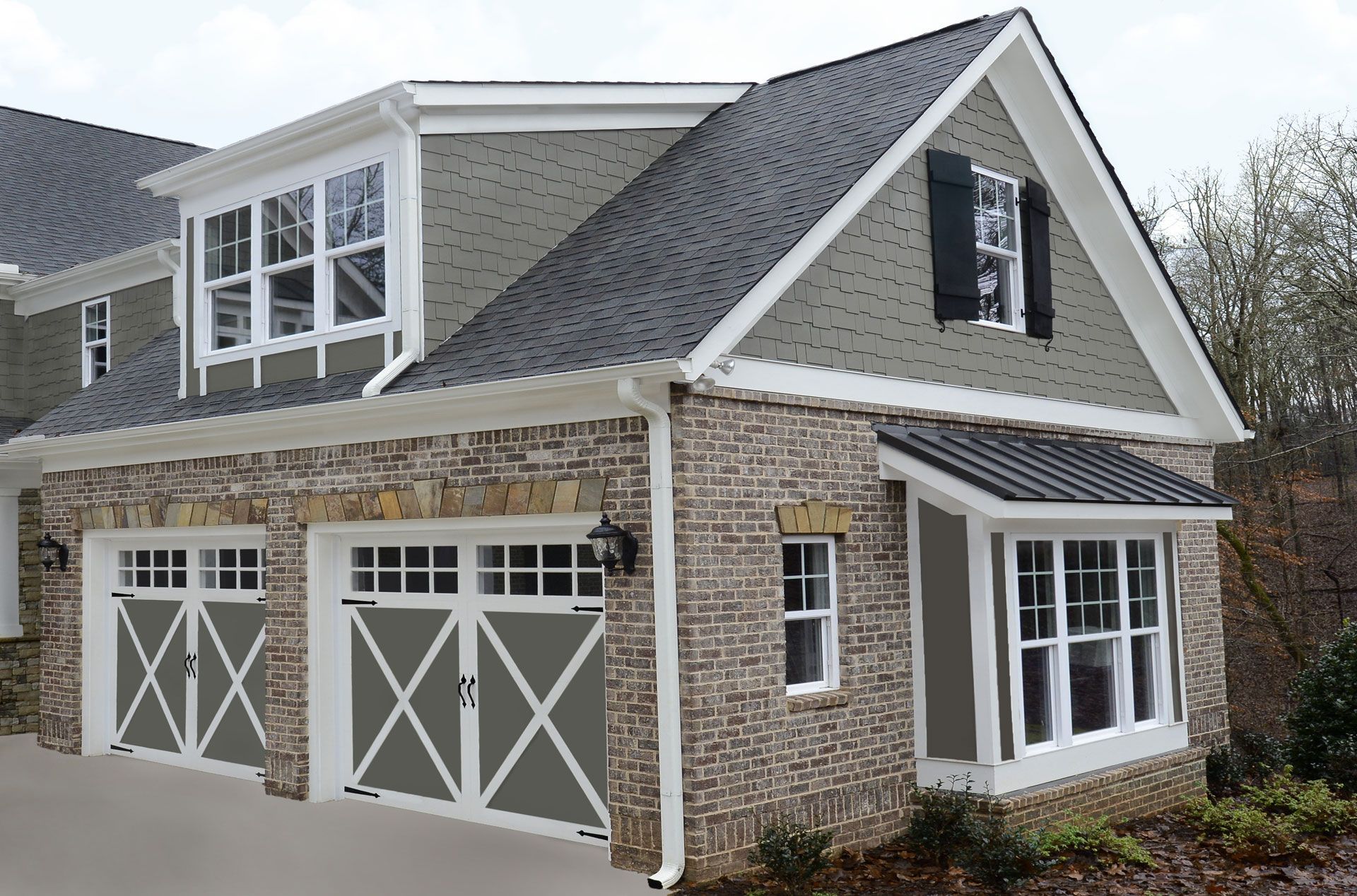 A house with two garage doors and a large window